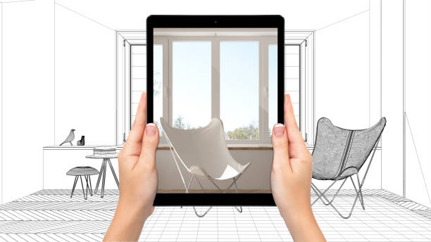 istock Hands holding tablet showing modern living room. Blueprint CAD sketch background, augmented reality concept, application to simulate furniture and interior design products 1154394192