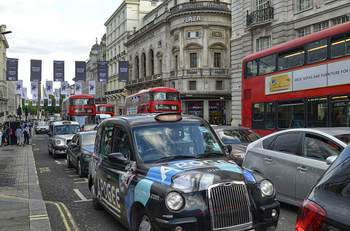 London, United Kingdom, 14 June 2018. London taxis, called cabs, are one of the symbols of the city. Classically of strictly black color. Sometimes with colorful sponsorships.