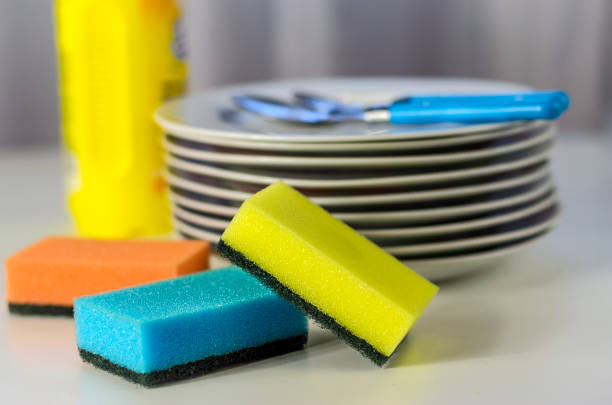 istock Bottle of dishwashing liquid and stack of utensils 1154395463