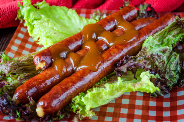 istock hunting sausages with sauce on a plate 1154395469
