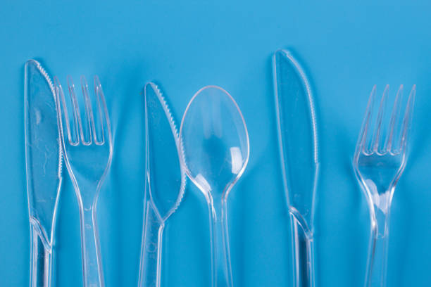istock plastic forks and knifes on blue background 1154395949