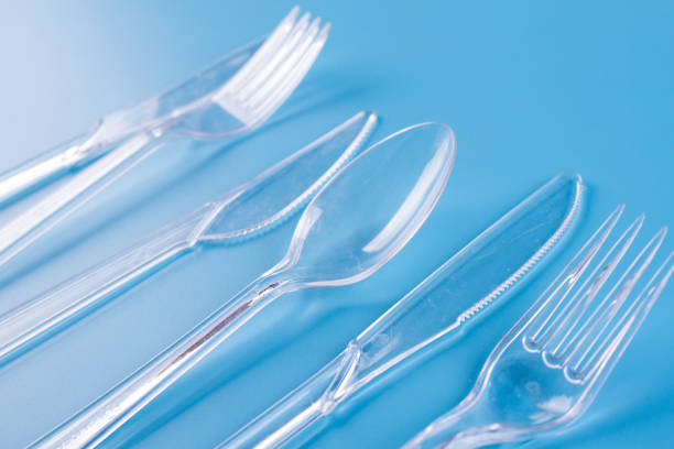 plastic forks and knifes on blue background