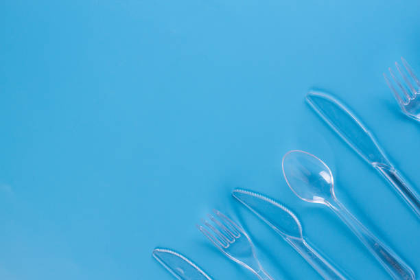 istock plastic forks and knifes on blue background 1154396486