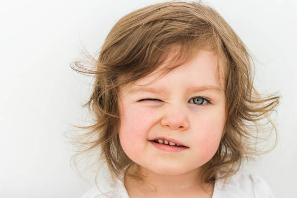 istock Happy funny baby eyewink isolated on white background 1154396554