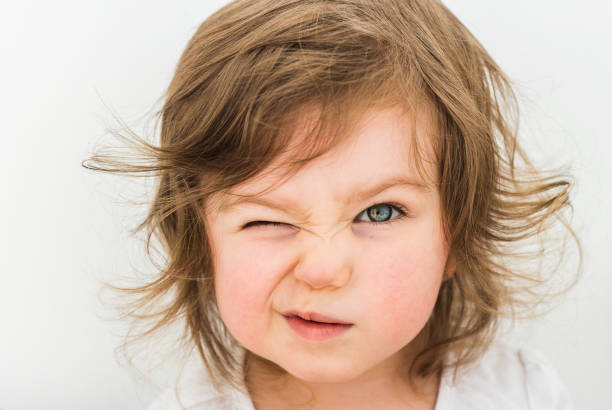 istock Happy funny baby eyewink isolated on white background 1154396559