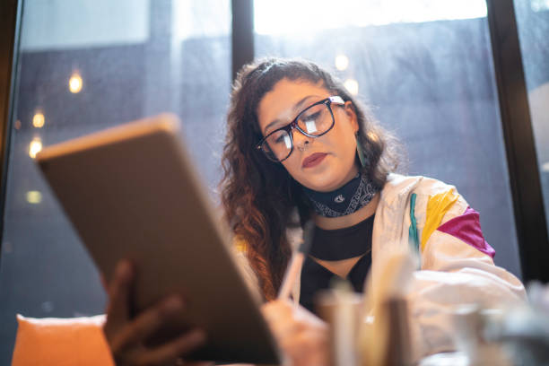 istock Latin woman analyzing some data from a digital investment using digital tablet 1154396816