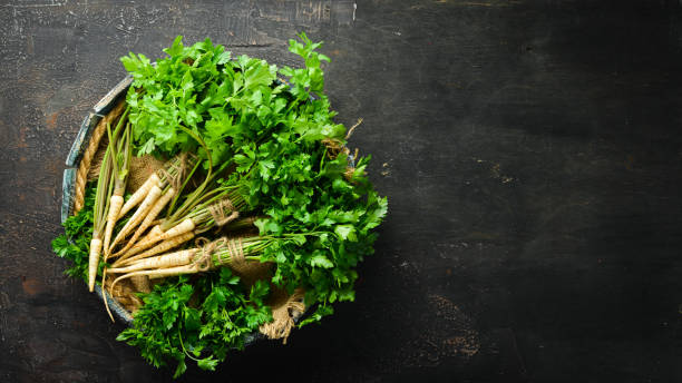 istock Root parsley on a wooden background. Top view. Free space for your text. 1154396986