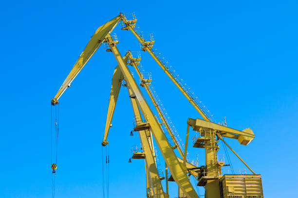 istock Mobile harbor cranes over blue sky. Transport and technology concept 1154397260