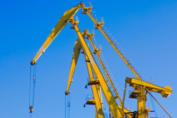 istock Mobile harbor cranes over blue sky. Transport and technology concept 1154397288
