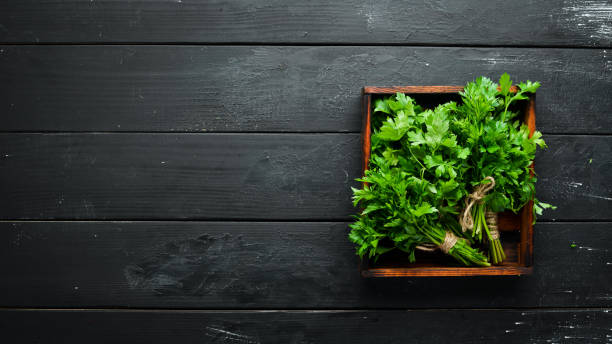 istock Fresh parsley on a wooden background. Top view. Free space for your text. 1154397408