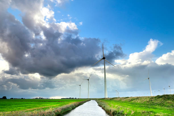 istock wind turbines over blue sky in summer, Holland 1154398125