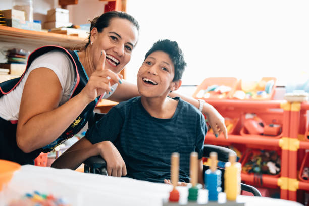Teacher playing with boy with Cerebral Palsy