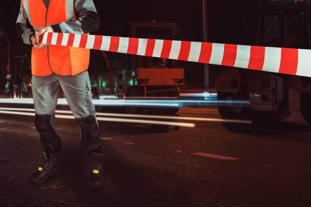 Worker blocks repair street