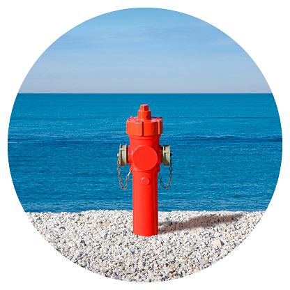 An improbable hydrant at the seaside - Plenty of water concept image - Round icon concept image - Photography in a circle