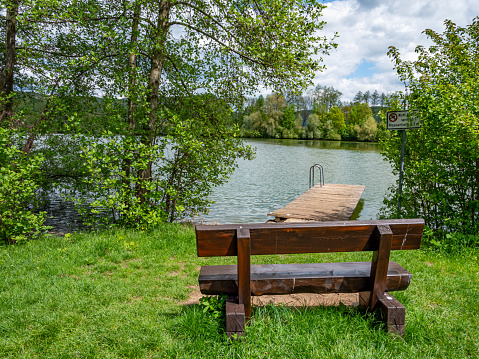 wooden bench at the lake in the countryside