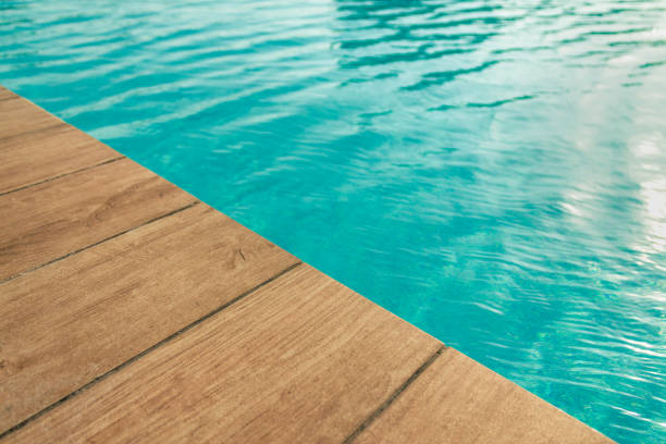 istock Pool with wood open copyspace area.  Beautiful clean swimming pool with bright blue water.  Luxury relaxation and lifestyle travel concept. 1154404194