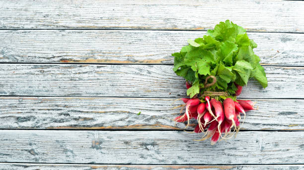istock Fresh radish on a white wooden table. Fresh vegetables. Top view. 1154406662