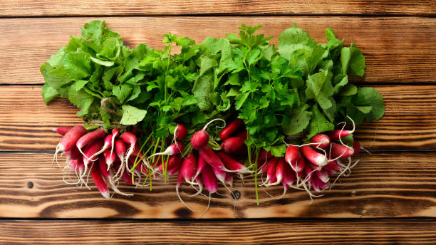 istock Fresh radish on a wooden table. Fresh vegetables. Top view. Free space for text. 1154406847