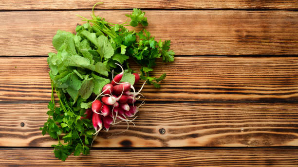 istock Fresh radish on a wooden table. Fresh vegetables. Top view. Free space for text. 1154406922