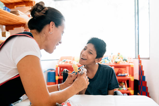 istock Teacher playing with boy with Cerebral Palsy 1154407029