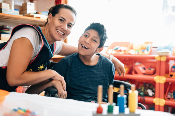 Teacher playing with boy with Cerebral Palsy