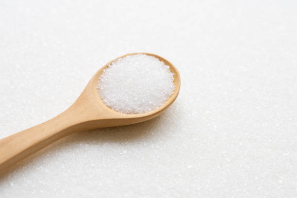 istock Wooden spoon with white granulated sugar. Top view 1154409013
