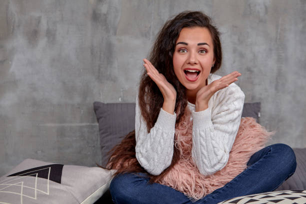 istock Young pretty attractive brunette woman posing before camera sitting on the floor 1154409123