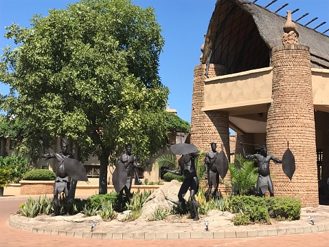 Kingdom Victoria Falls Zimbabwe warriors statues outside hotel entrance sunny day travel holiday Africa