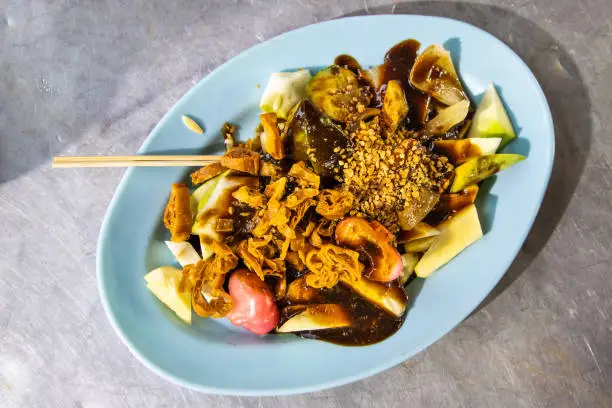 Photo of Popular Penang fruit rojak served with prawn paste and groundnuts