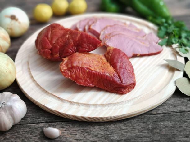 istock Rustic wooden board with smoked meat on wooden board 1154410981