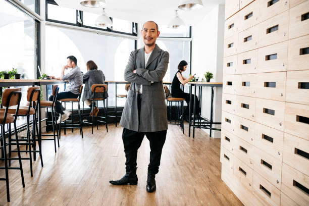 Successful businessman standing in modern office and smiling