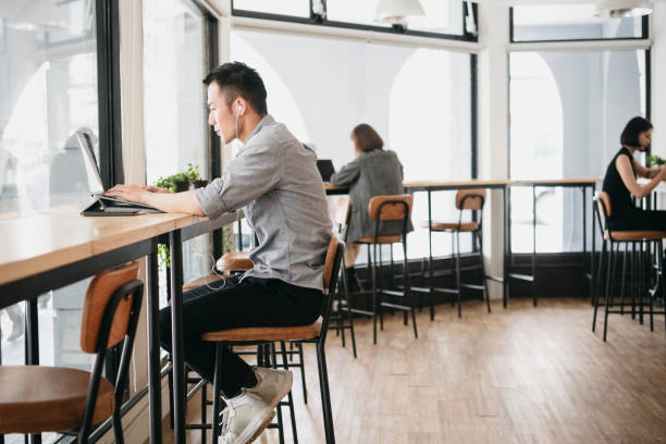 istock Freelancer working on laptop and wearing earphones 1154411540
