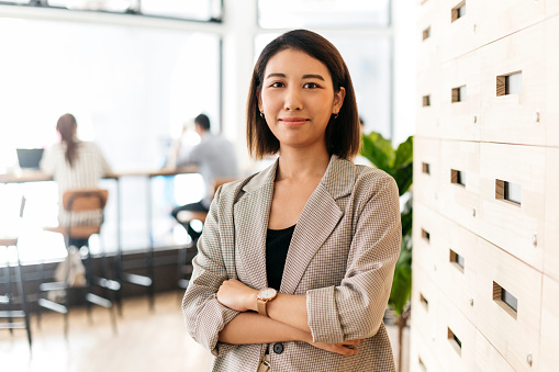 Young Asian woman with arms crossed, confidence, businesswoman, manager