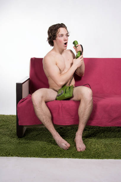 istock Sexy young guy talking on the phone. 1154411562