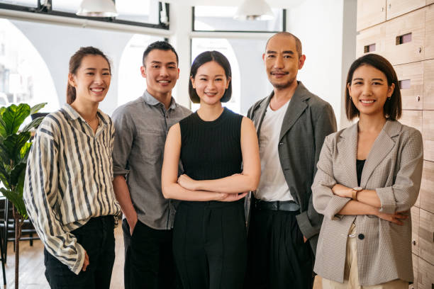 istock Five colleagues in smart casual clothing standing in office 1154411595