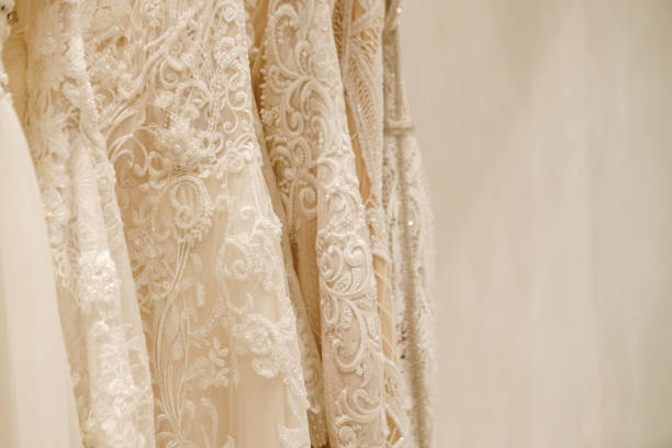 istock Cream wedding dresses hanging on the rack 1154413431