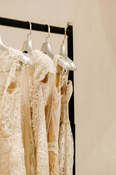 istock Cream wedding dresses hanging on the rack 1154413439