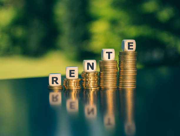 Symbol for a pension increase. Dice form the German word "Rente" ("pension" in English) on increasing high stacks of coins. Symbol for a pension increase. Dice form the German word "Rente" ("pension" in English) on increasing high stacks of coins. gold ira companies gold stock pictures, royalty-free photos & images