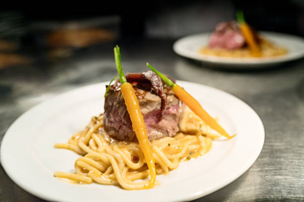 istock Steak with spaghetti baby carrots and sardines. 1154414936