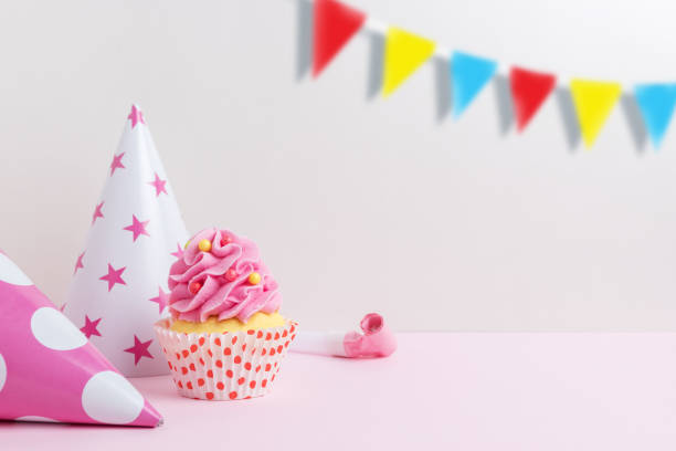 istock Colorful celebration background with various party decoration and cupcake. Minimal party concept. 1154414944