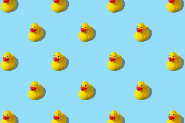 istock Trendy summer pattern with yellow rubber duck on bright blue background. Minimal summer concept. 1154414989