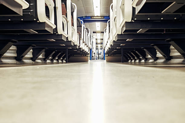 istock Train seats in a train compartment in white optics with wood at a train station at night 1154415738