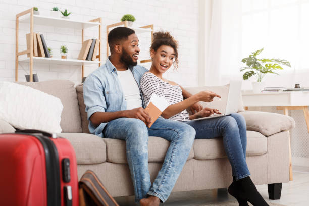 istock Happy couple searching places to visit using laptop 1154415775