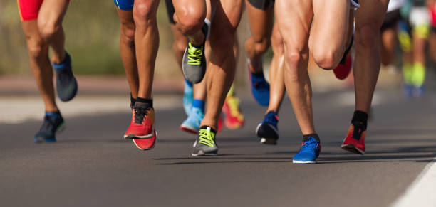 Marathon running race Marathon running race, people feet on city road human leg stock pictures, royalty-free photos & images