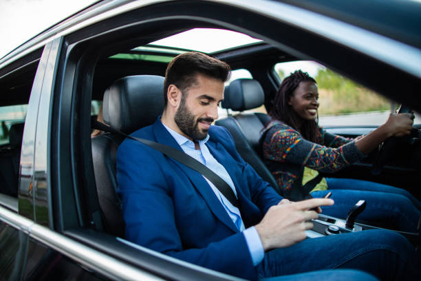 istock Handsome businessman using smart phone during car drive 1154420103