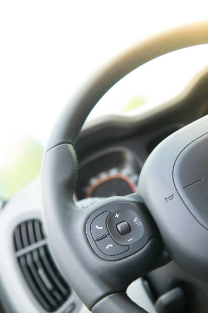 istock Close up of a steering wheel with remote control, blurry dashboard 1154421095