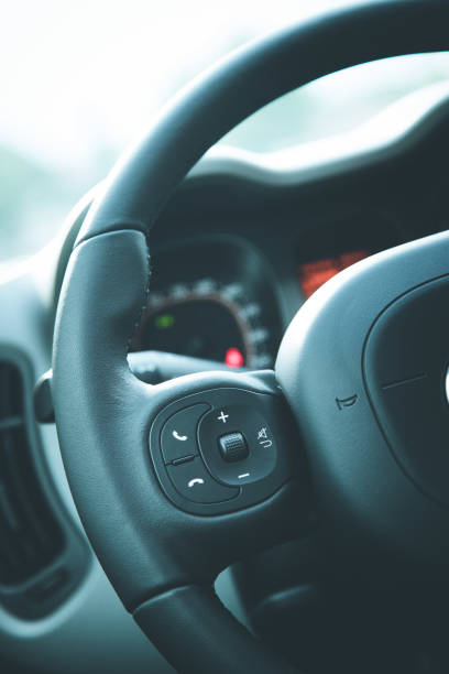 istock Close up of a steering wheel with remote control, blurry dashboard 1154421588