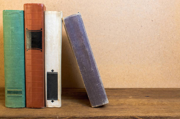old books stacked on a wooden shelf, retro style