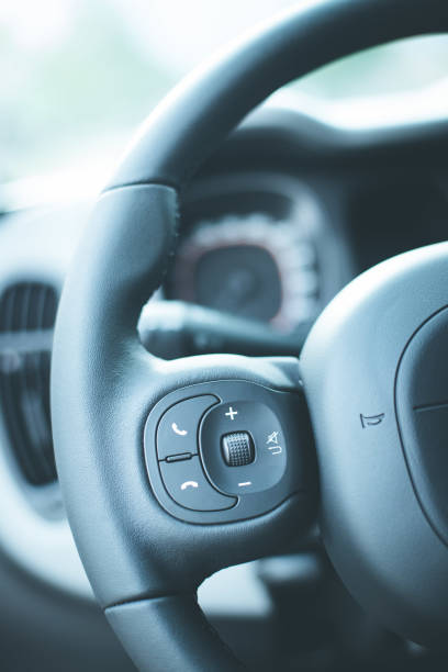 istock Close up of a steering wheel with remote control, blurry dashboard 1154422353