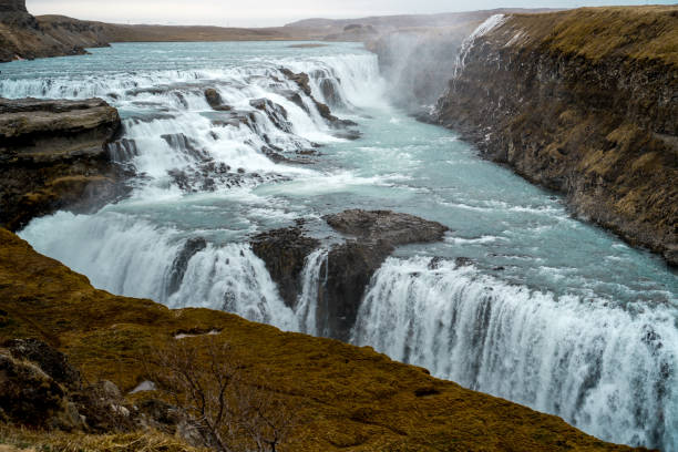 istock beautiful iceland waterfall with rocks and skies 1154424117